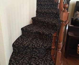Black carpeted stairs with elegant design.