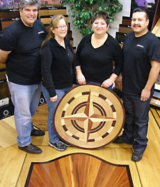 Slaughterbeck floors employees posing for team photo on the showroom floor.