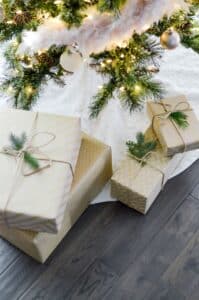 Christmas Tree placed on hardwood floor.