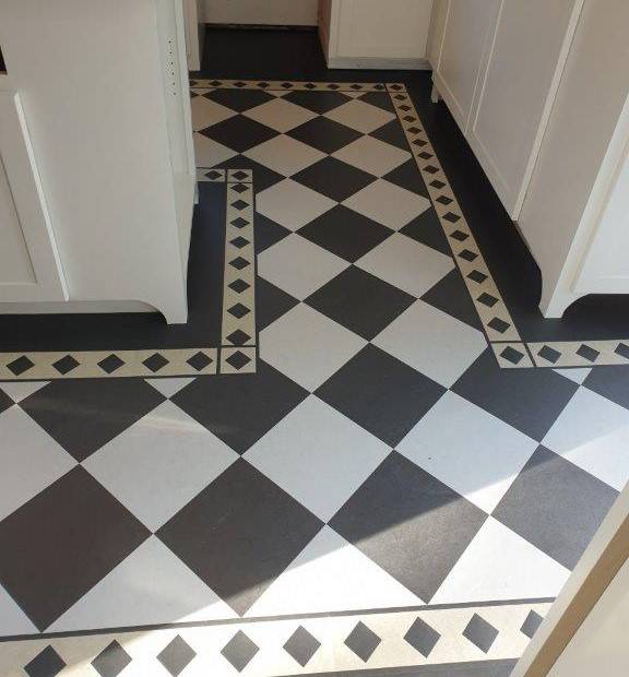 A new Forbo Marmoleum Linoleum floor installed in the kitchen with a checkerboard design.