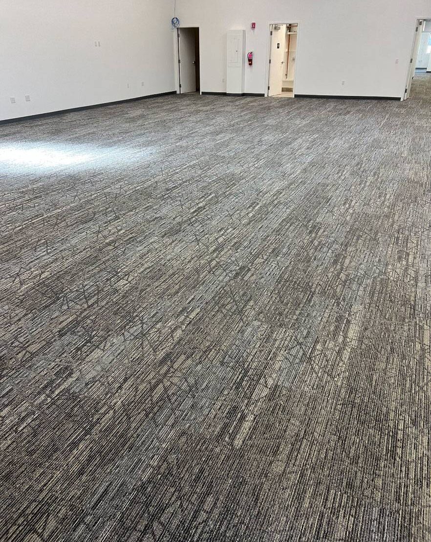 Brand new gray carpeting installed in a commercial office building.