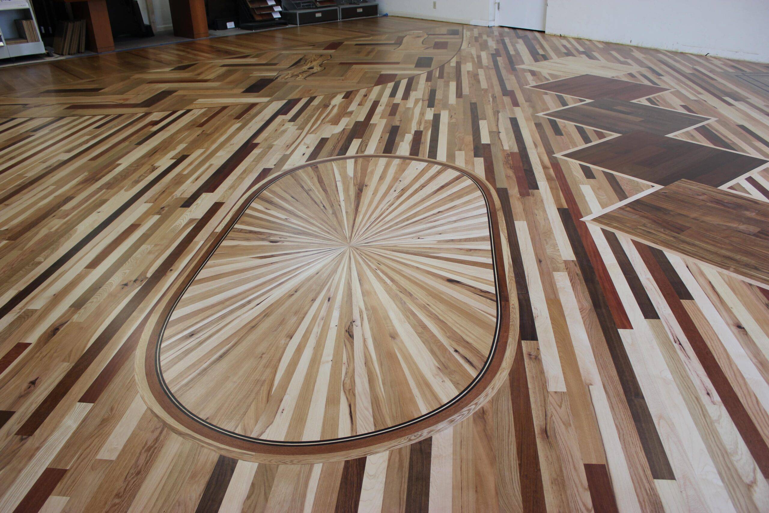 Closeup of remodeled showroom floor’s custom starburst medallion at Slaughterbeck Floors.