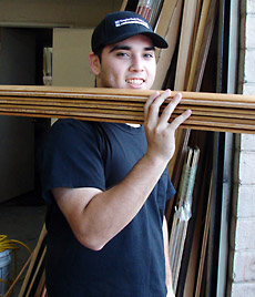 Slaughterbeck Floors employee carrying flooring materials at work.
