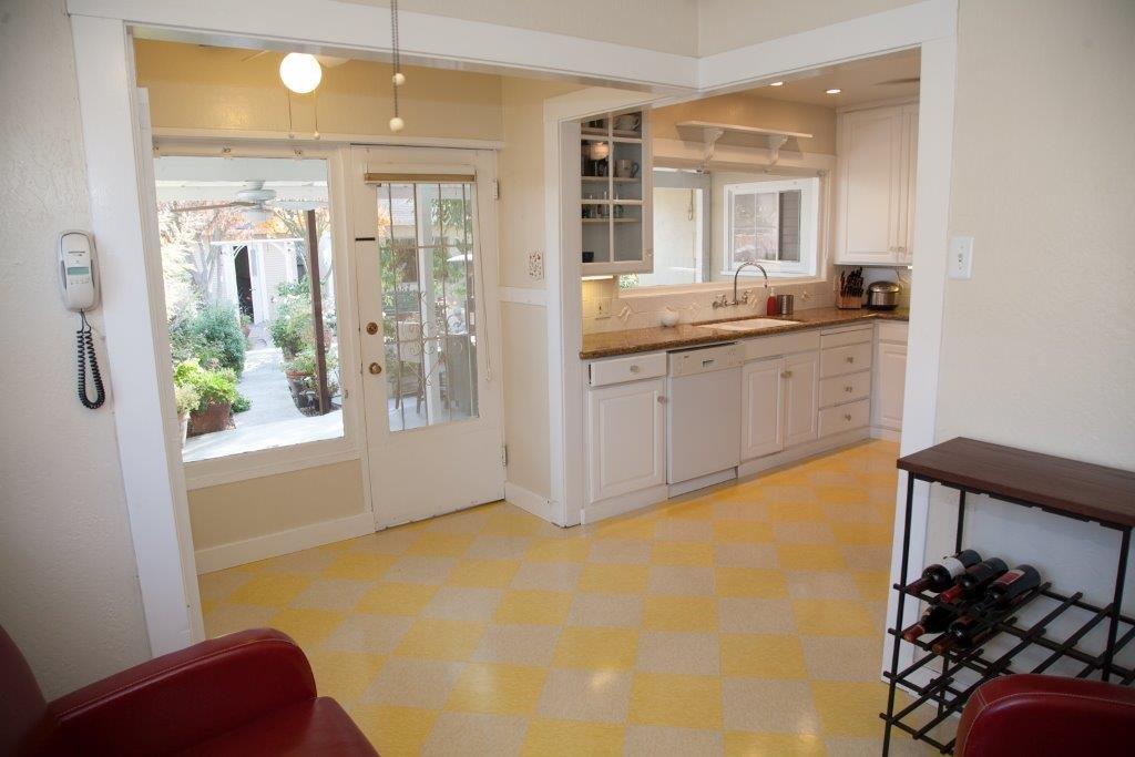 Yellow checkerboard floor installed in San Jose home using vinyl composition tile.